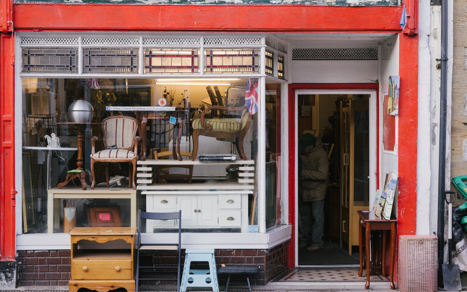 The Harbor & Heirloom storefront from the street, its windows full of vintage furniture, on Bjune Drive SE a few blocks up from the Bainbridge ferry dock